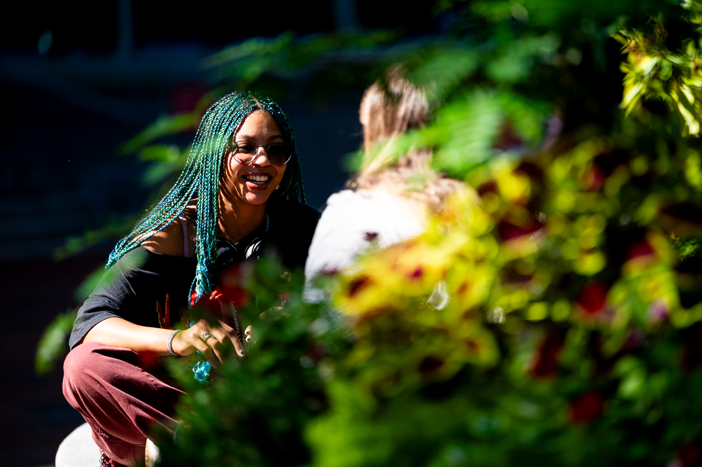 Two students laugh while having a conversation.