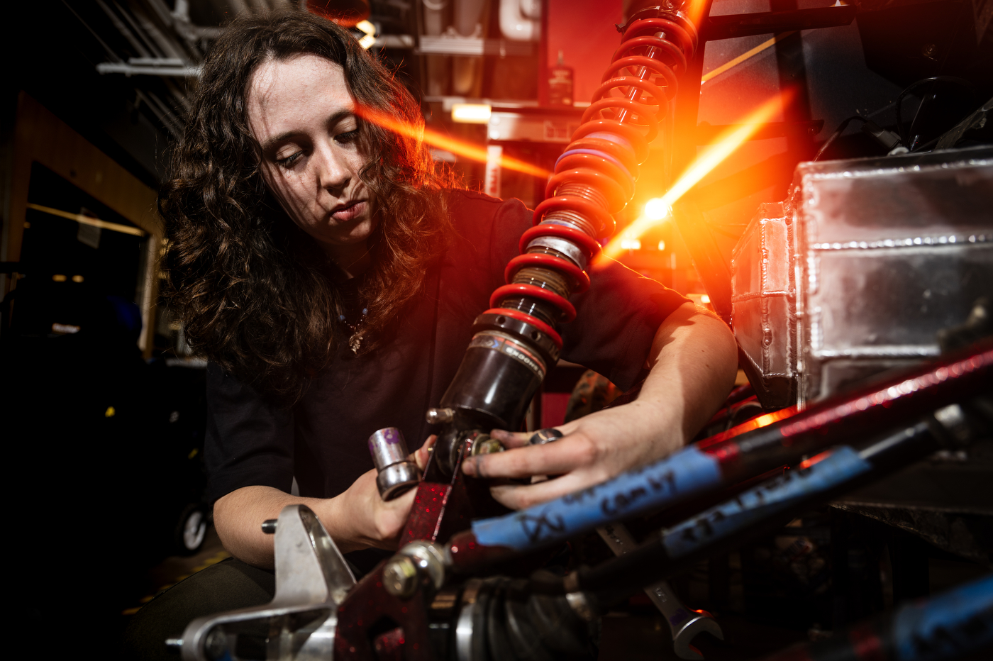 Julia McDonough, a fourth year technical engineering major and Baja new member manger, works on the Northeastern Baja SAE off-road vehicle in the COE Makerspace in Richards Hall.