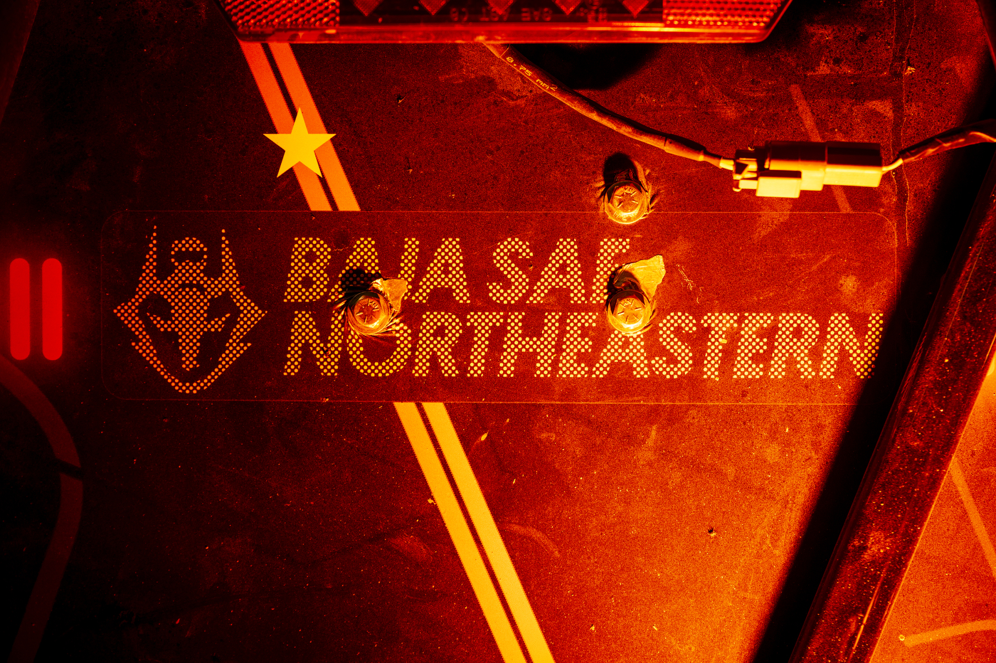 Details of the 27th model of the Northeastern Baja SAE club off-road vehicle in the COE Makerspace in Richards Hall.