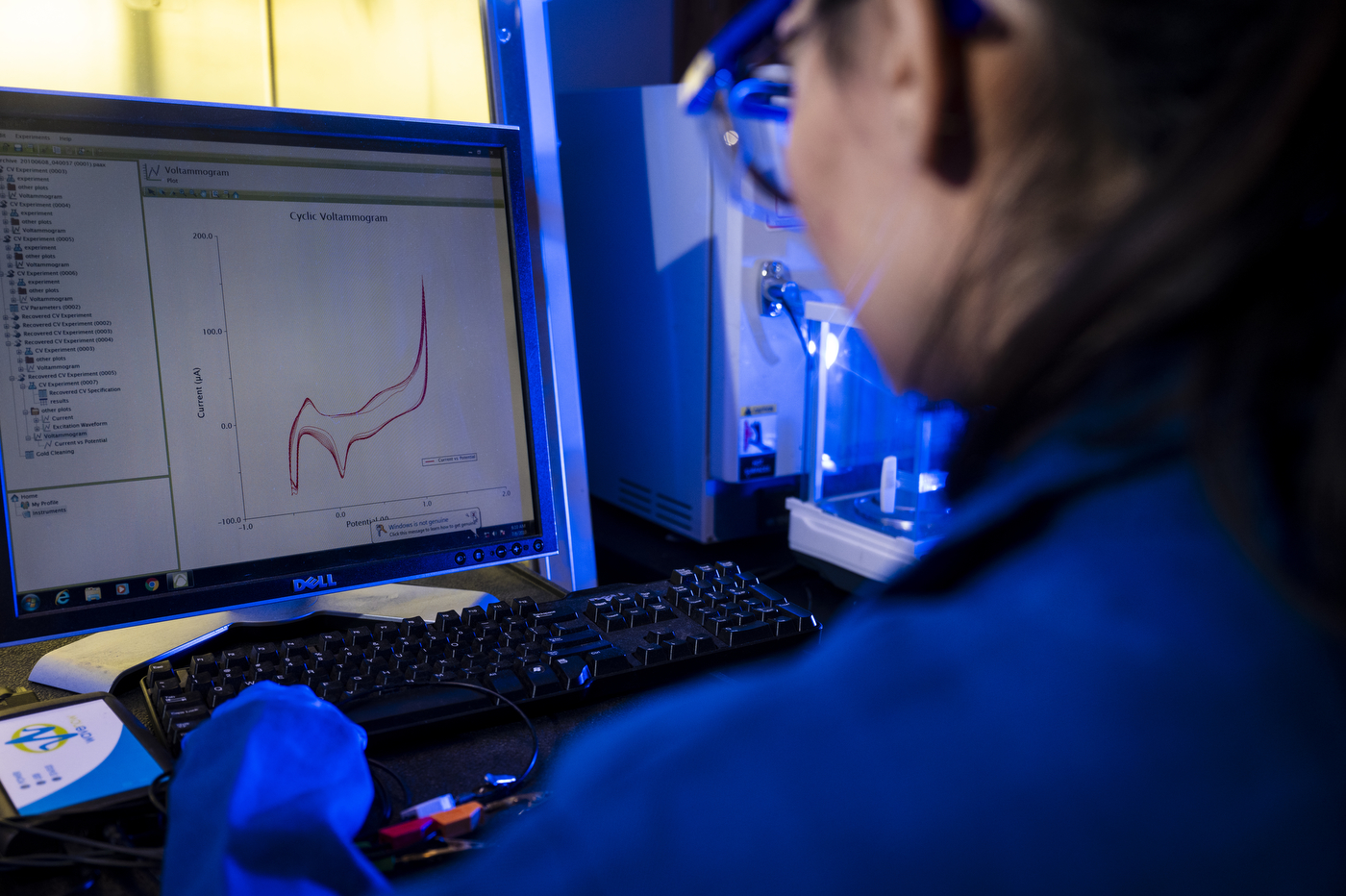 Northeastern postdoctoral researcher Pardis Sadeghi examines sensor data on a computer in a laboratory.