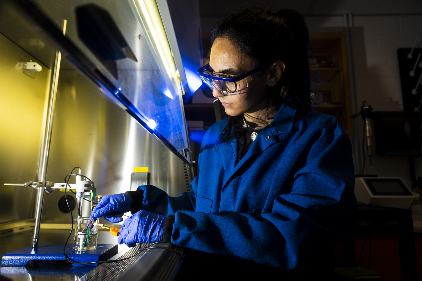 Northeastern postdoctoral researcher Pardis Sadeghi works inside a laboratory testing enclosure.
