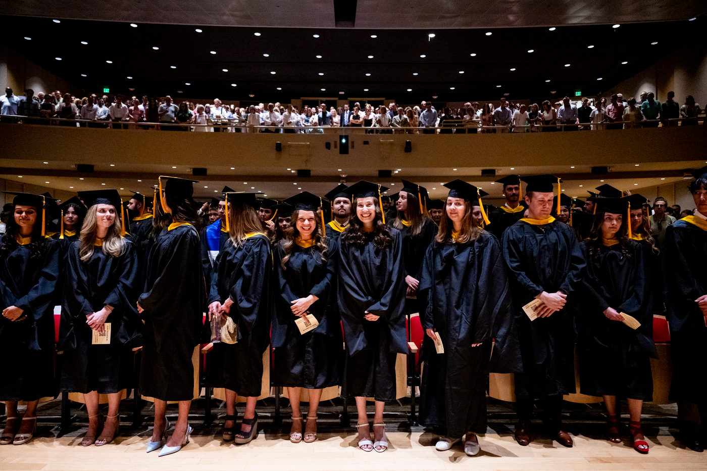 Wide view of graduates in caps and gowns seated in Blackman Auditorium during the Bouvé College Physician Assistant and Physical Therapy Graduation Celebration.