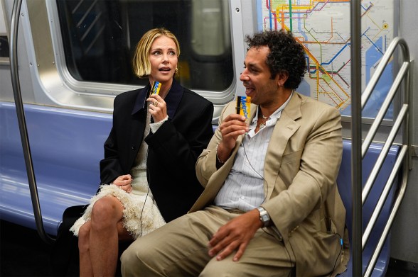Charlize Theron and Kareem Rahma are seen on the subway.