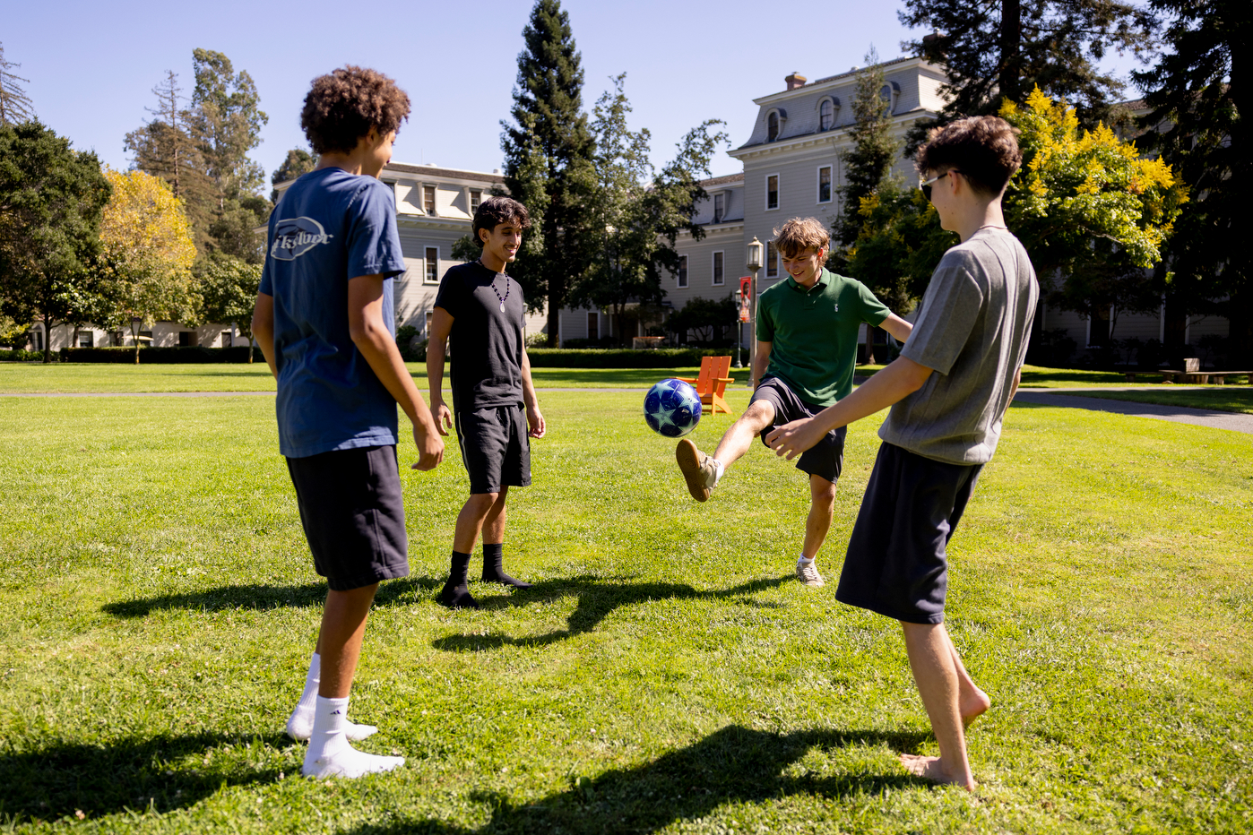 Students play soccer on Holmgren Meadow at Northeastern's Oakland campus.