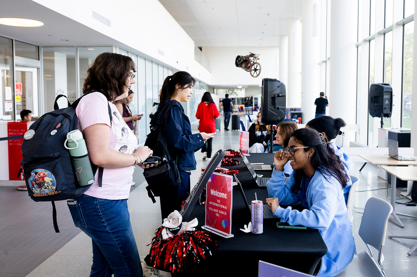 Students gather in a campus building lobby during move-in day.