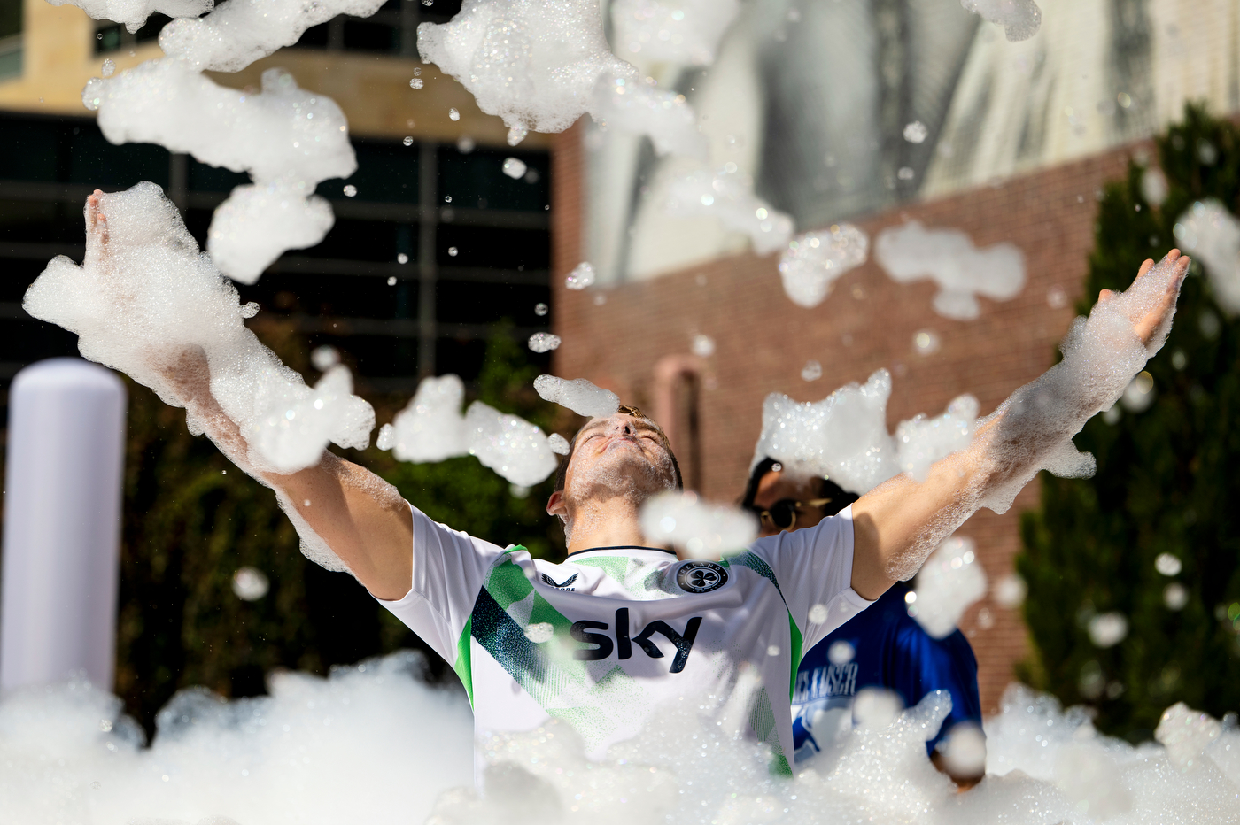 Incoming student Carl Clark dances through a cloud of foam during the Welcome Week BBQ on Centennial Common.