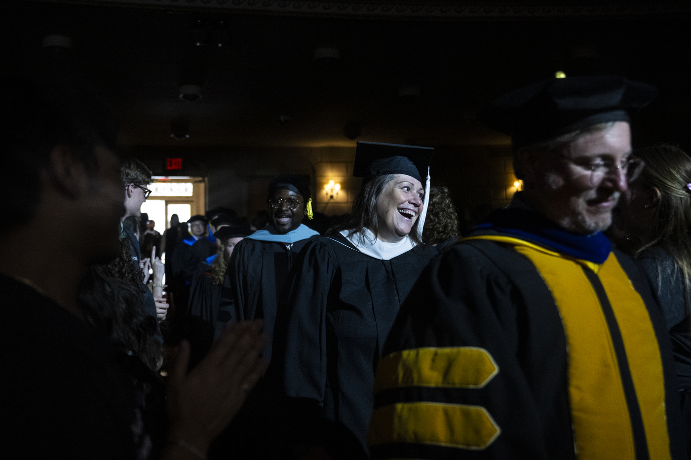 Faculty members in academic regalia walk through the auditorium during Northeastern University’s New York City convocation at The Town Hall.