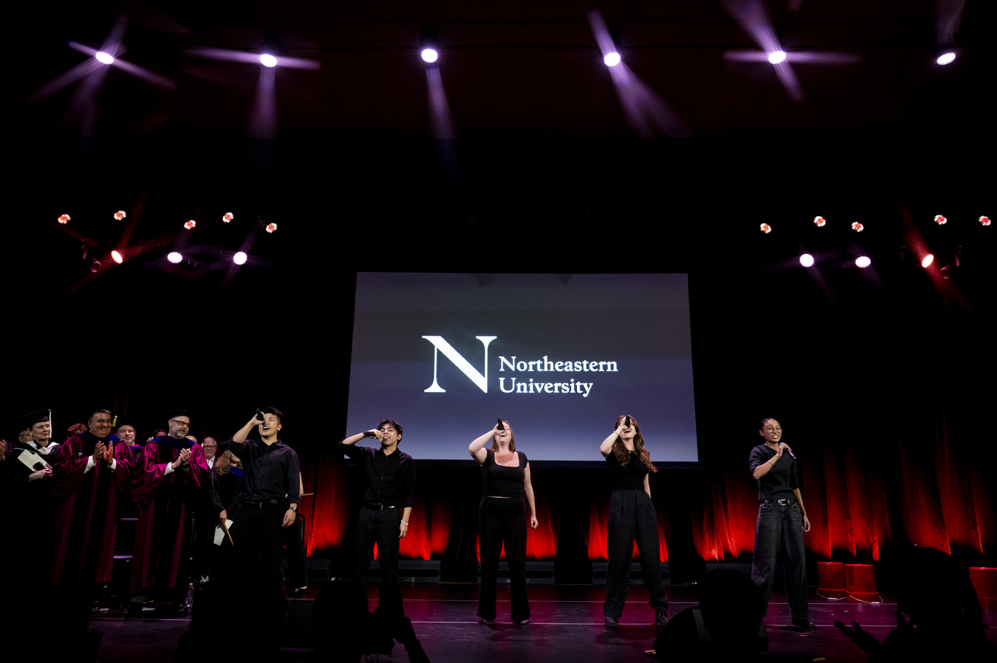 Students and performers gather onstage during Northeastern University’s New York City convocation at The Town Hall.