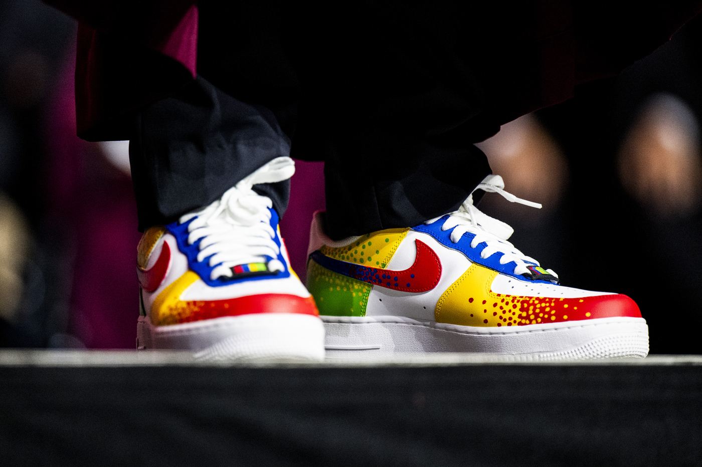 Close-up of colorful sneakers worn by President Joseph E. Aoun, in a red, yellow, blue, green, and white pattern.