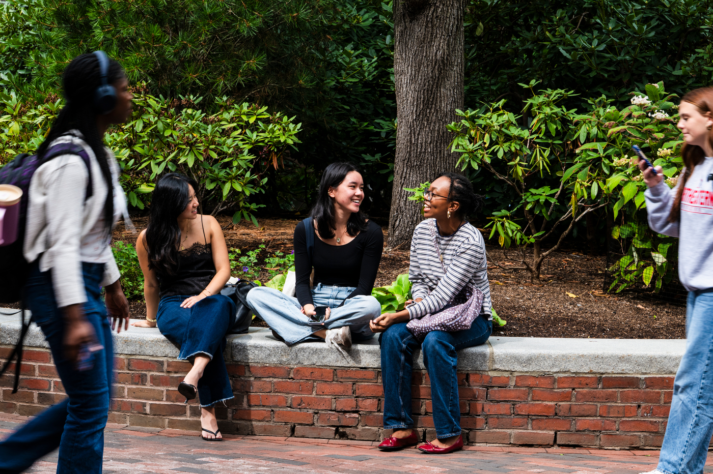 A group of students sit outside and talk.