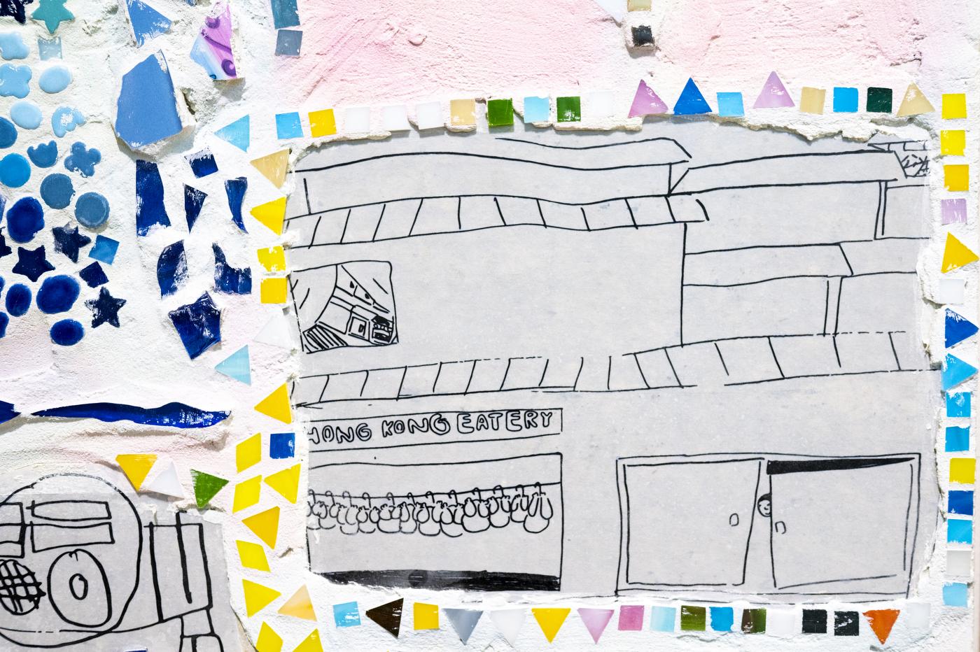 Close-up of a colorful mosaic panel with line-drawn buildings and blue, yellow and purple geometric tiles at the "Can You Hear the City?" exhibit.