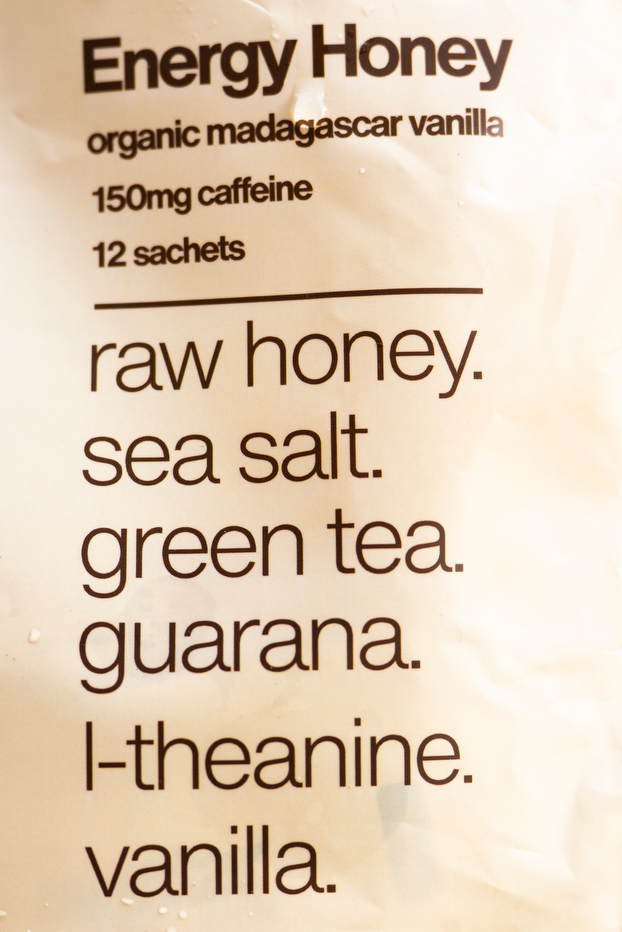 Energy Honey package label for organic Madagascar vanilla flavor, listing 150 mg caffeine, 12 sachets, and ingredients of raw honey, sea salt, green tea, guarana, L-theanine and vanilla.