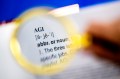 A magnifying glass held over a dictionary entry for "AGI."