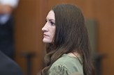 Clancy in profile, wearing a green top, expression tense as she looks toward the jury box.